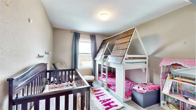 carpeted bedroom with a textured ceiling