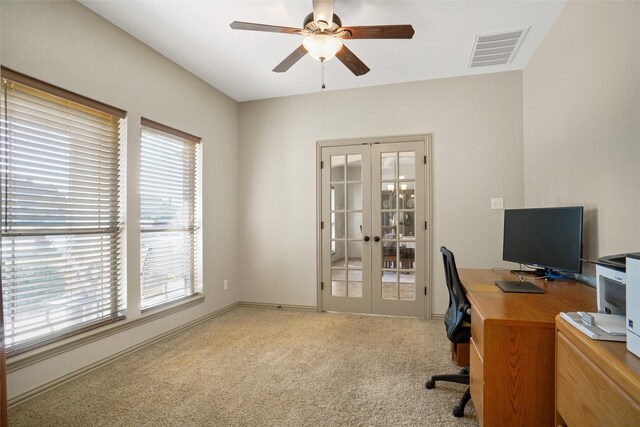 carpeted home office with french doors and ceiling fan