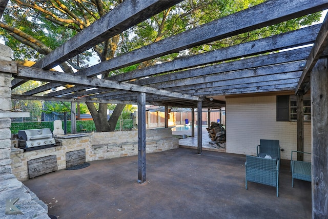 view of patio / terrace featuring a pergola, an outdoor kitchen, and grilling area