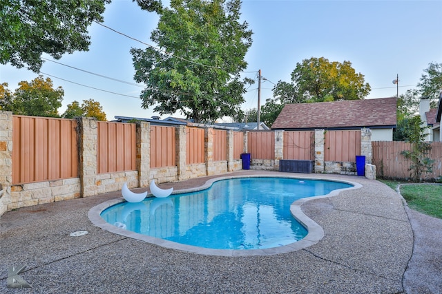 view of pool with a storage shed