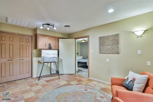 living area with a textured ceiling