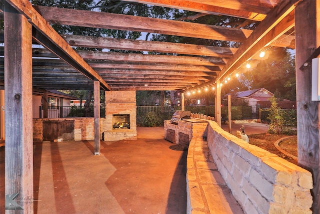 view of patio / terrace featuring an outdoor stone fireplace and exterior kitchen