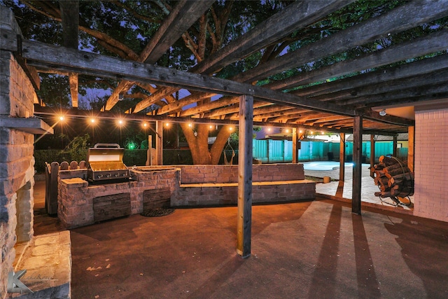 view of patio / terrace with an outdoor stone fireplace, area for grilling, and a grill