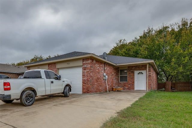 ranch-style house featuring a front yard and a garage