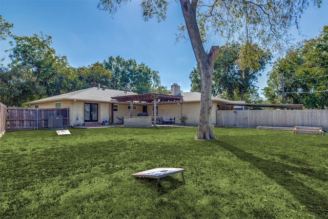 back of property with a patio, a yard, and central air condition unit