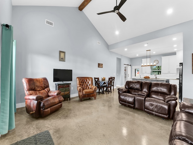 living area with visible vents, beamed ceiling, concrete flooring, high vaulted ceiling, and ceiling fan with notable chandelier