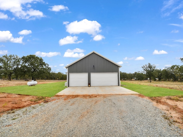 detached garage with a rural view