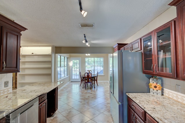 interior space with ceiling fan, french doors, and a textured ceiling