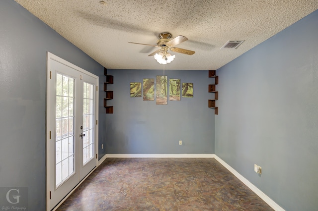 carpeted spare room featuring a textured ceiling and track lighting