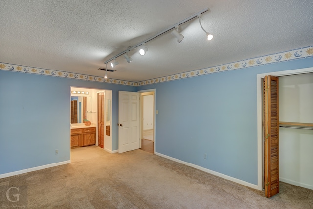 full bathroom with toilet, vanity, a textured ceiling, and tiled shower / bath