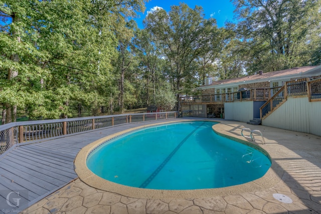 view of swimming pool with a wooden deck