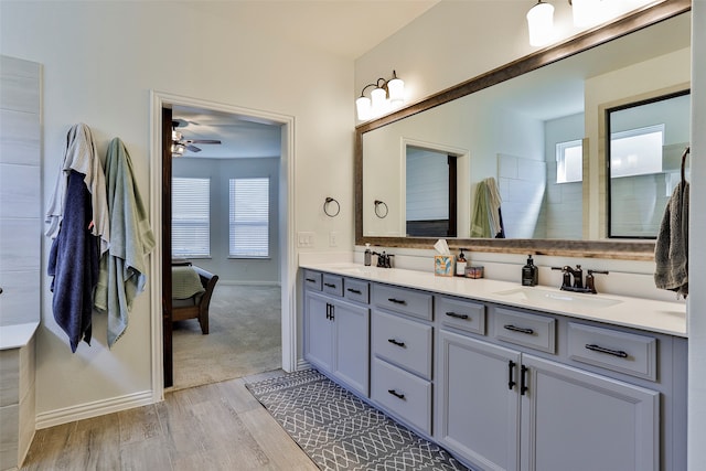 bathroom featuring walk in shower, vanity, hardwood / wood-style flooring, and ceiling fan