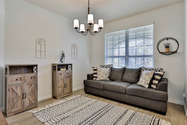 living room featuring a chandelier and wood-type flooring