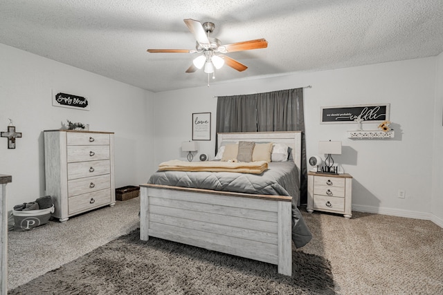 bedroom featuring a textured ceiling, carpet flooring, and ceiling fan