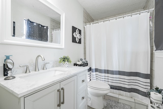 bathroom with vanity, curtained shower, a textured ceiling, and toilet