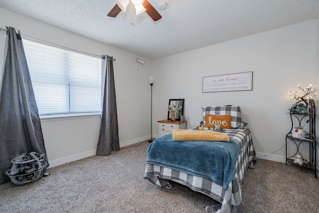 bedroom featuring carpet, a textured ceiling, and ceiling fan