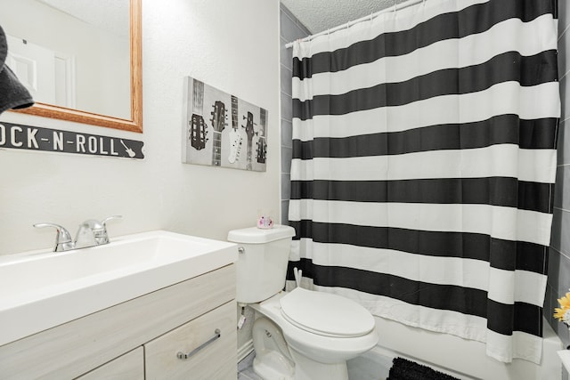 bathroom featuring vanity, toilet, and a textured ceiling