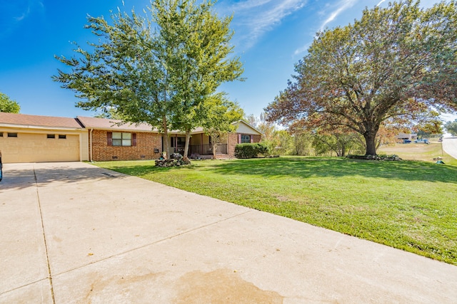 ranch-style home featuring a front lawn and a garage