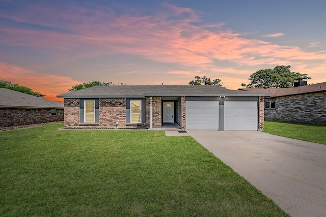 ranch-style home with a yard and a garage