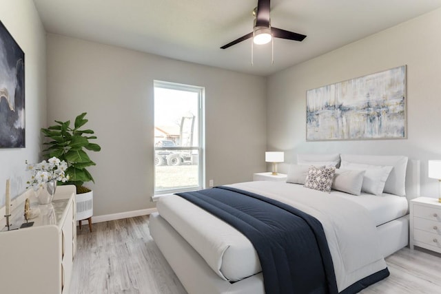 bedroom featuring baseboards, ceiling fan, and light wood-style floors