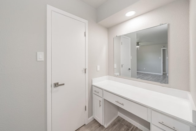 bathroom featuring vanity, wood-type flooring, and ceiling fan