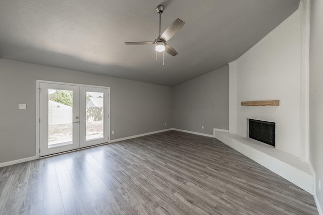 unfurnished living room featuring french doors, ceiling fan, wood-type flooring, and a textured ceiling