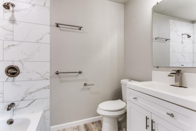 full bathroom with bathtub / shower combination, toilet, vanity, wood finished floors, and baseboards