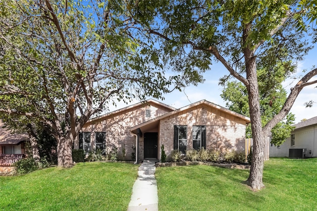 ranch-style home with a front yard and central AC