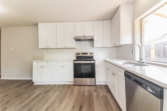 kitchen with white cabinetry, appliances with stainless steel finishes, and plenty of natural light