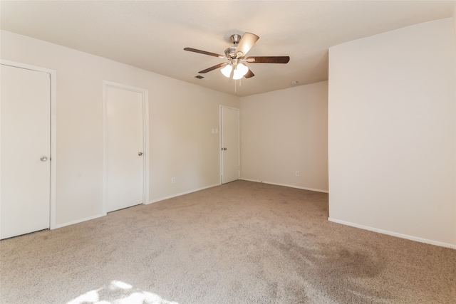 unfurnished bedroom featuring ceiling fan and light colored carpet