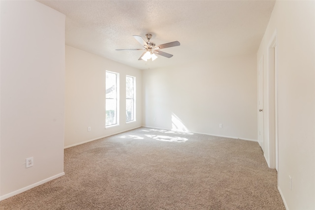 spare room with ceiling fan, carpet flooring, and a textured ceiling