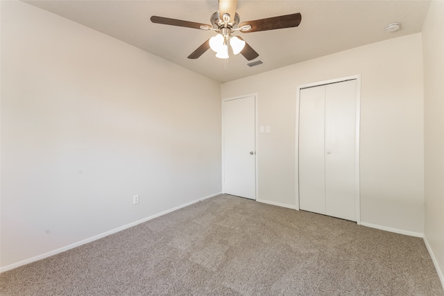 unfurnished bedroom featuring a closet, ceiling fan, and carpet floors