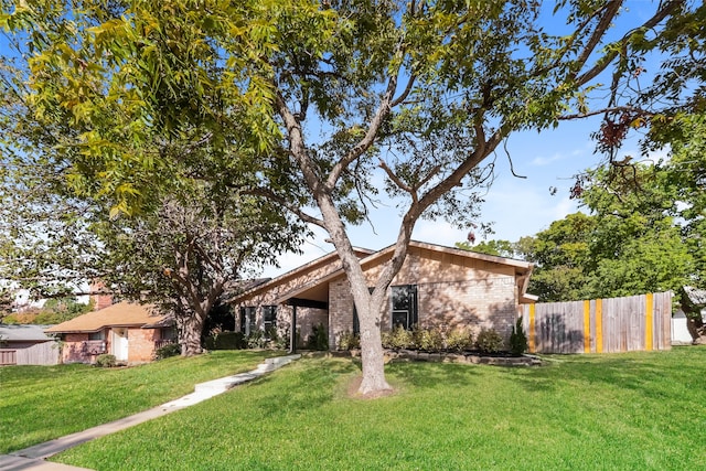 ranch-style house featuring a front lawn