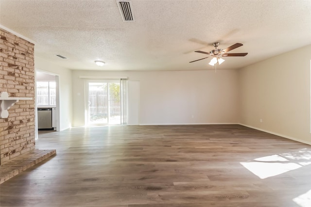 5037 Collingwood Dr, Garland, TX 75043 - unfurnished living room featuring a ceiling fan, a textured ceiling, visible vents, and wood finished floors