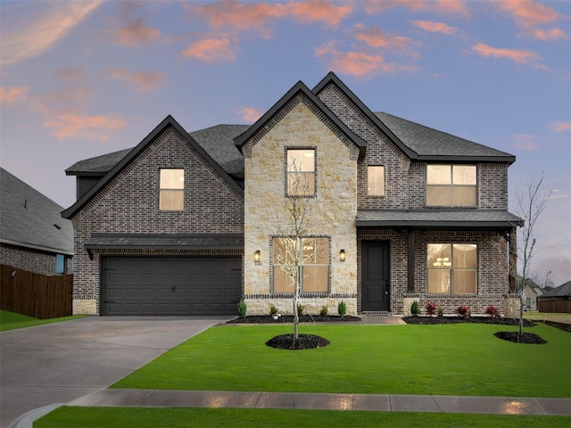 french country inspired facade with a yard and a garage