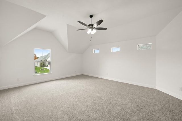 bonus room with ceiling fan, plenty of natural light, carpet, and lofted ceiling