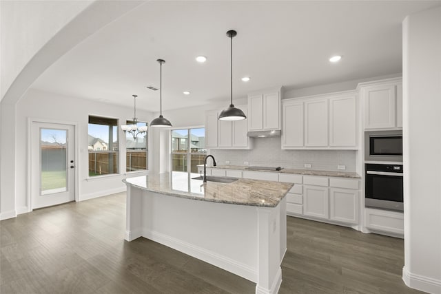 kitchen featuring an island with sink, stainless steel appliances, white cabinetry, and sink