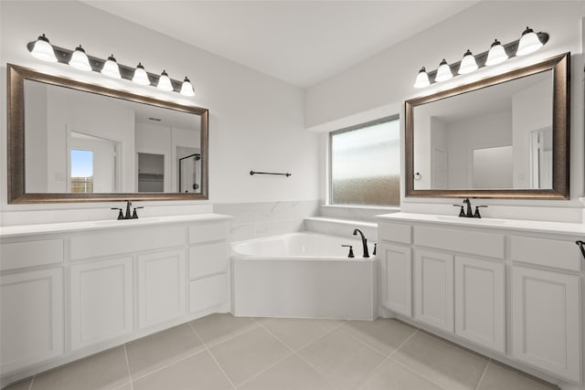 bathroom featuring tile patterned floors, a tub, and vanity