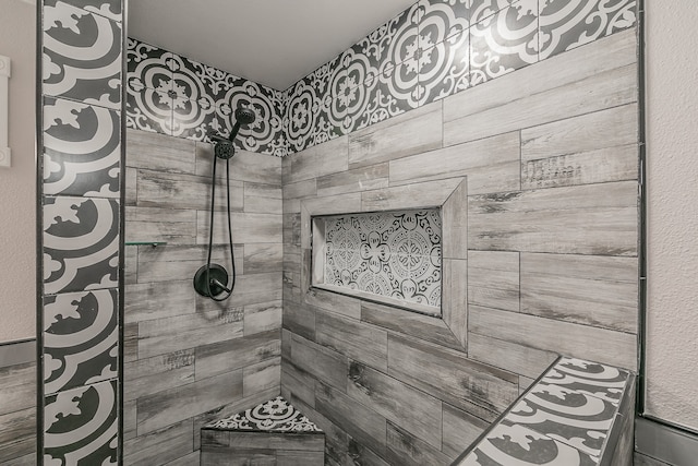 bathroom with a tile shower