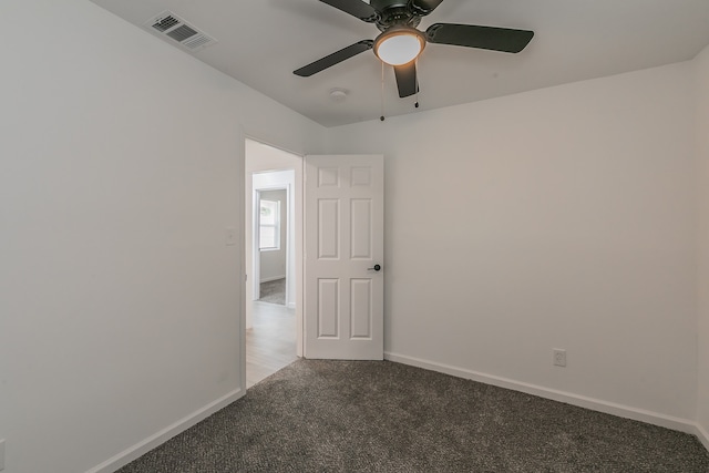 spare room featuring carpet and ceiling fan