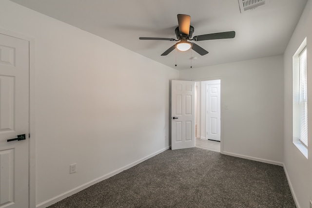 carpeted empty room with a wealth of natural light and ceiling fan