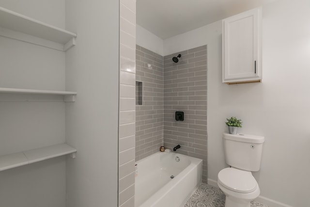 bathroom featuring toilet, tiled shower / bath, and tile patterned floors