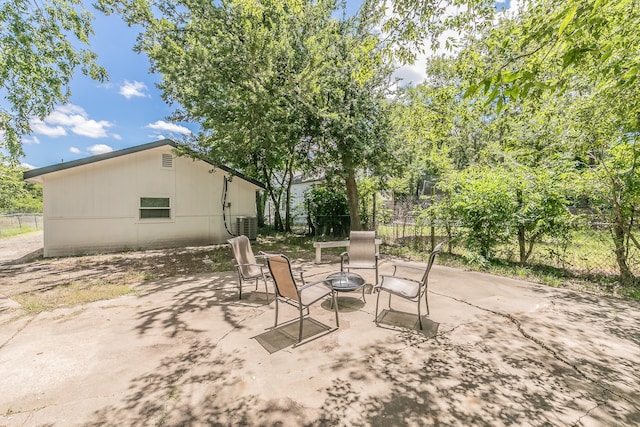 view of patio featuring cooling unit and a fire pit