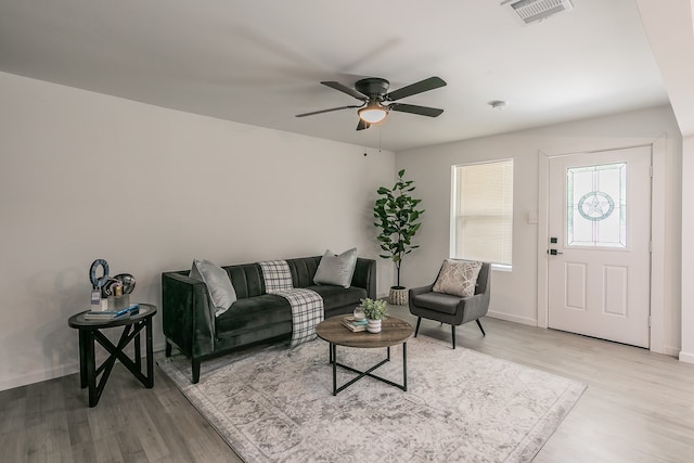 living room featuring ceiling fan and light wood-type flooring