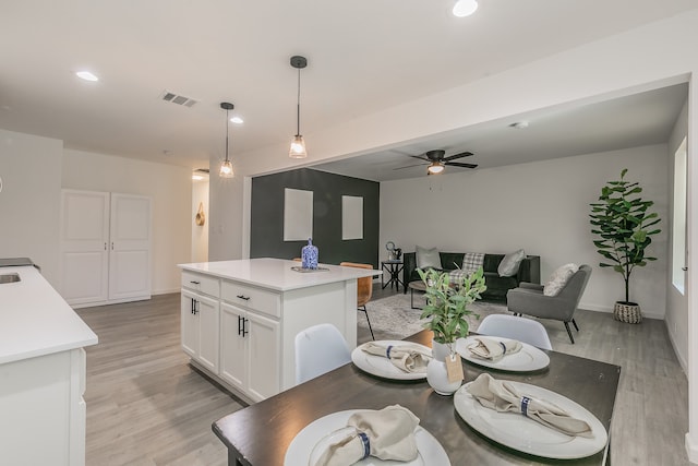 dining area with light hardwood / wood-style flooring and ceiling fan