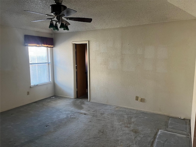 carpeted spare room with ceiling fan and a textured ceiling