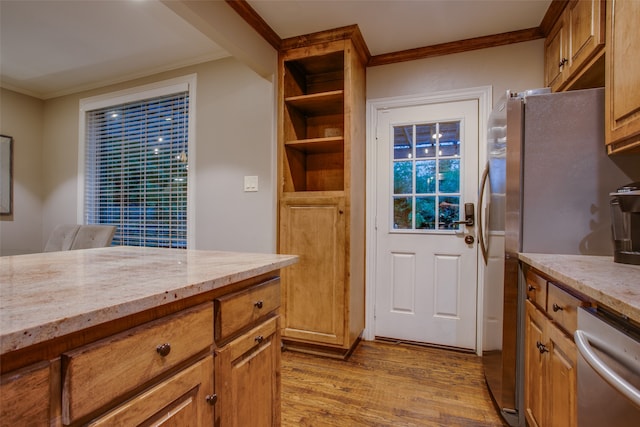 kitchen with light stone countertops, dishwasher, light wood-type flooring, and ornamental molding