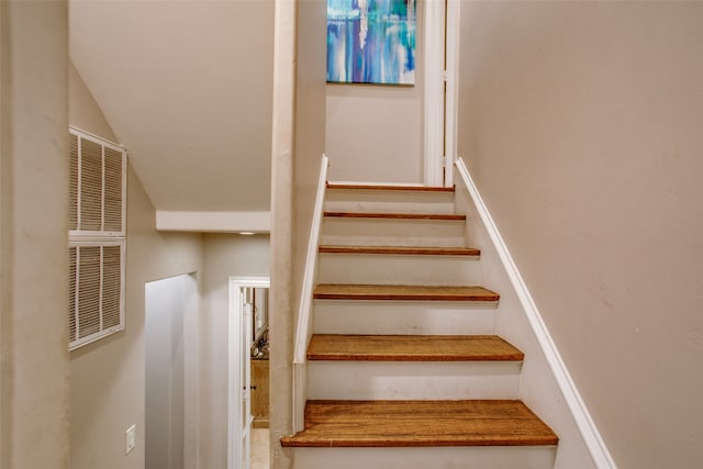 staircase with vaulted ceiling