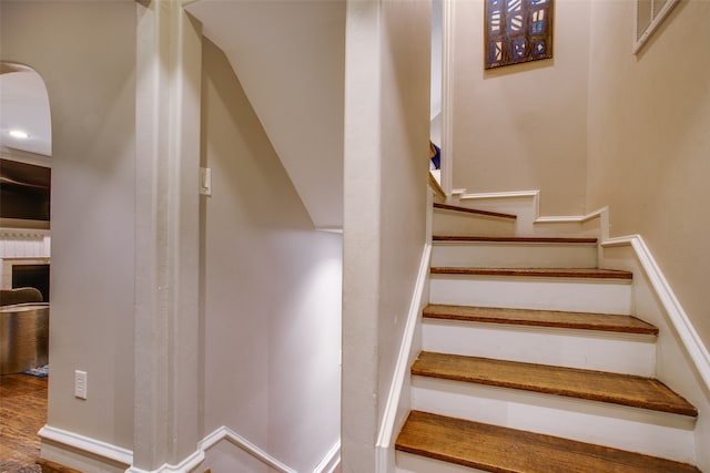 staircase with hardwood / wood-style floors