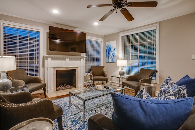 living room with ornamental molding, tile patterned flooring, a fireplace, and ceiling fan